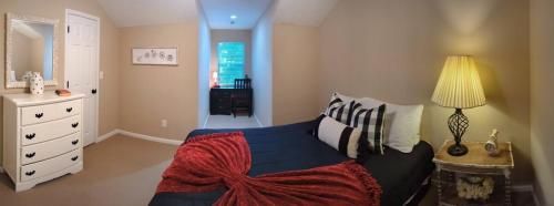 a bedroom with a blue bed and a white dresser at Home Away From Home Charlotte in Charlotte