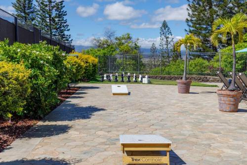 a patio with a bench and some plants and a fence at 6 Bed 4 Bath Condo in Waikoloa Village in Waikoloa Village