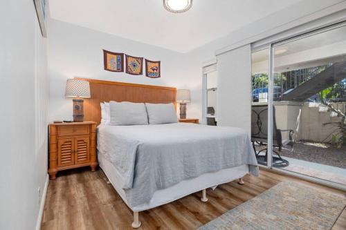 a bedroom with a large bed and a window at 6 Bed 4 Bath Condo in Waikoloa Village in Waikoloa Village