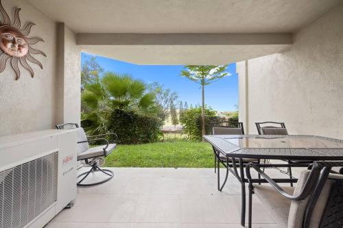 a patio with a table and a table and chairs at 6 Bed 4 Bath Condo in Waikoloa Village in Waikoloa Village