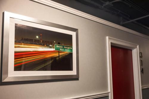 a framed picture of a street sign on a wall at American Hotel in Los Angeles