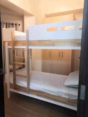 a couple of bunk beds in a room at Saint Honore Executive: 6 guests, 5 beds, 2 bedrooms, 2 bathrms in Iloilo City