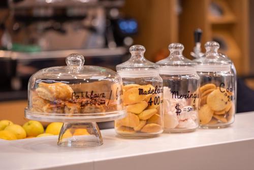 four glass jars filled with different types of food at Holiday Inn Express - Yerevan by IHG in Yerevan