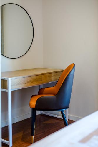 a desk with a chair and a mirror at StayAU Magnificent Lakefront Villa Stunning Views in Point Cook