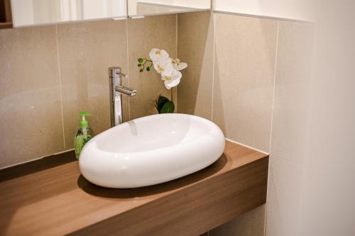 a white sink on a counter in a bathroom at StayAU Magnificent Lakefront Villa Stunning Views in Point Cook