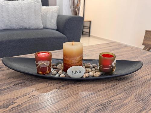 a tray with candles and rocks on a table at Meteora countryside villa in Kalabaka
