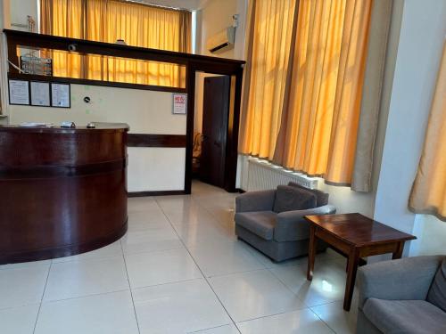 a waiting room with a large room with a chair and a table at Hotel Skib in Tbilisi City