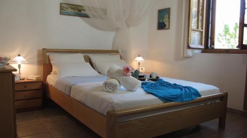 a bedroom with a bed with a teddy bear on it at Mani Apartments in Agios Nikolaos