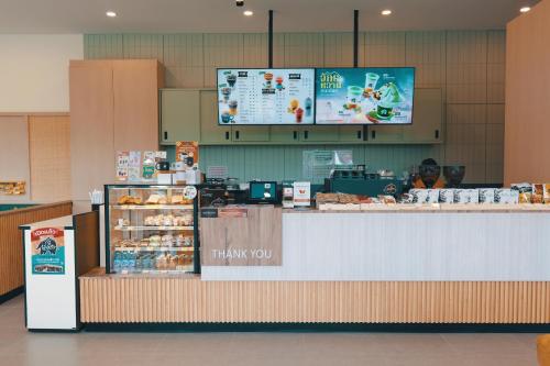 a food counter in a store with a man behind it at Metro Point Bangkok in Bangkok