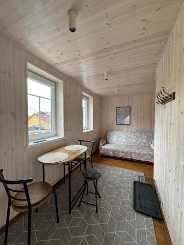 a room with a table and chairs and a bed at Kopa Cabana in Palanga
