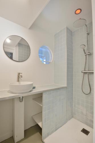 une salle de bain avec un lavabo et une douche dans l'établissement Stylish attic conversion, à Paris