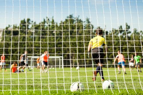 a group of people playing soccer on a field at Youth Hostel Proteus Postojna in Postojna