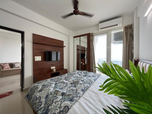 a bedroom with a bed and a ceiling fan at Sanidhya Home in Vrindāvan