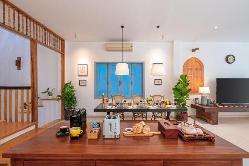 a living room with a table with food on it at Villa Nautica By The Beach - Vesta Collections in Hoi An