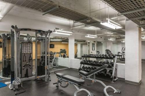 a gym with lots of equipment in a room at Large 1 Bed apt in the Heart of Downtown in Des Moines