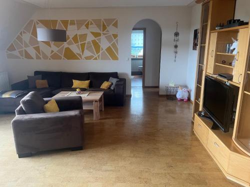 a living room with a couch and a table at Ferienwohnung Dörfler in Hollfeld