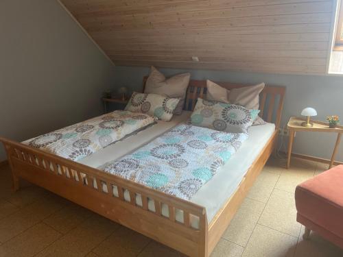 a bed with two pillows on it in a room at Ferienwohnung Dörfler in Hollfeld