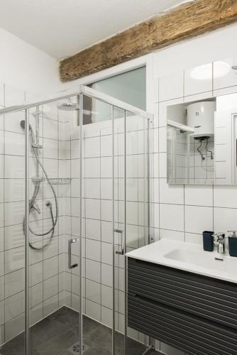 a bathroom with a glass shower and a sink at LevOasi 7 - Garden, jacuzzi and sauna escape in Levo