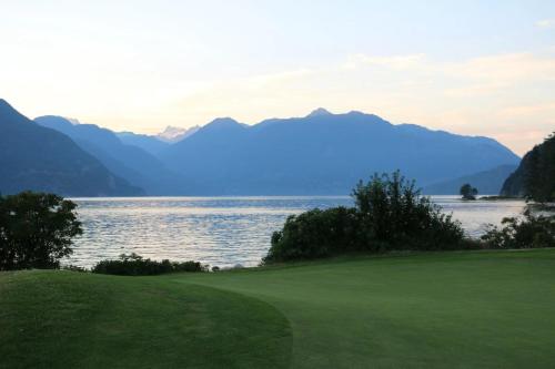 a golf course with a view of the water and mountains at Scorpion Hiuse Langley ROOM B in Langley