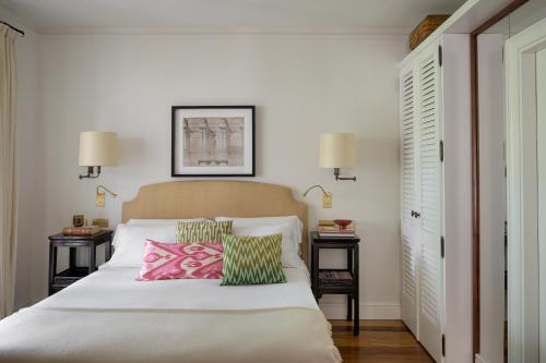 a bedroom with a white bed with two night stands at California Park Hotel in Forte dei Marmi
