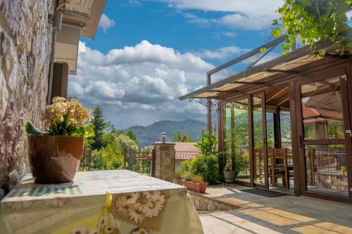 a patio with a table with a vase on it at Liontos Rooms in Pramanta