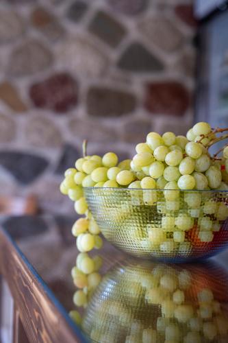 a bowl of grapes on top of a table at Liontos Rooms in Pramanta