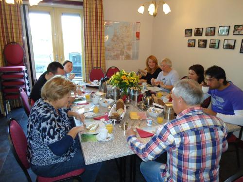 a group of people sitting around a table eating at Hoeve Meerzicht in Monnickendam