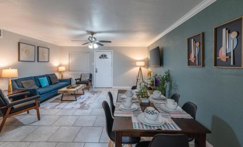 a living room with a table and a blue couch at Beautiful Apartment at The Botanical Gardens #1 in San Antonio