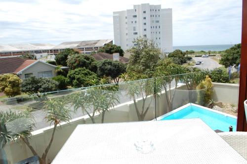 a balcony with a view of a pool and a building at Isango Gate in Port Elizabeth