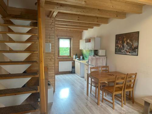 a kitchen and dining room with a table and chairs at Vila Horček in Smokovce