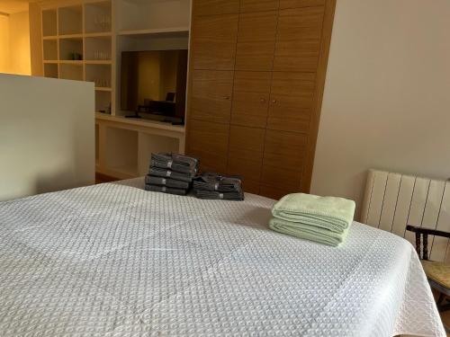 a bedroom with a bed with a towel on it at Las Estrellas de Soria in Soria