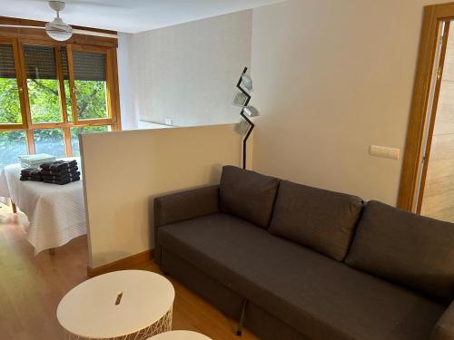 a living room with a couch and a table at Las Estrellas de Soria in Soria