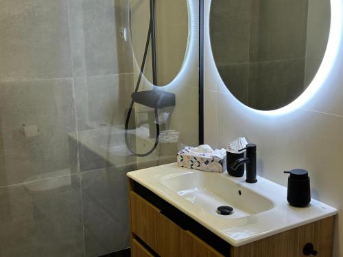 a bathroom with a sink and a shower with a mirror at Las Estrellas de Soria in Soria