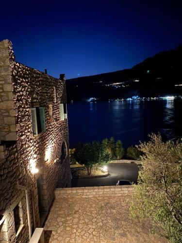 a building with a view of the water at night at Vatoulia House in Neon Oitilon