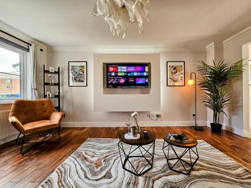 a living room with a chair and a television at Glasgow Green Modern Stay in Glasgow