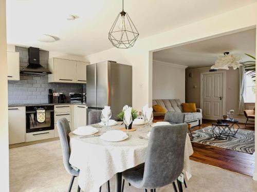 a kitchen and living room with a table and chairs at Glasgow Green Modern Stay in Glasgow