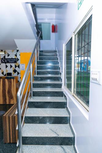 a staircase in a school building with a window at Hotel Natasha Regency Bangalore Airport in Bengaluru