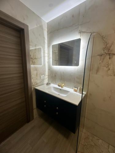 a bathroom with a sink and a mirror at Emerella Luxury Suites-Siderno Lungomare in Siderno Marina