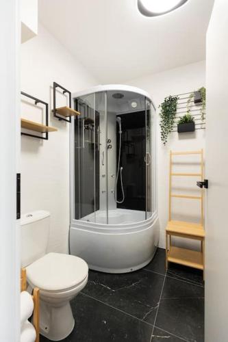 a white bathroom with a shower and a toilet at Dahlia Blooming Studio in Baia Mare