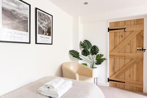 a bedroom with a bed and a wooden door at The Coach House in Lea