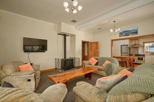 a living room with two couches and a coffee table at Villa Family Friendly Classic Charm in Kaikoura