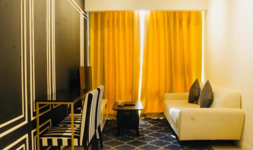 a living room with a couch and a chair and a window at Axon Residence KLCC - KL HOME in Kuala Lumpur