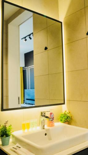 a bathroom sink with a large mirror above it at Axon Residence KLCC - KL HOME in Kuala Lumpur