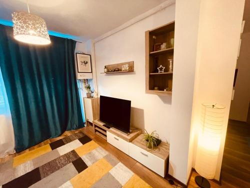 a living room with a flat screen tv on a wall at Cluj City Vivo Apartament Ametist in Floreşti
