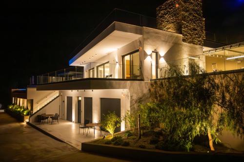 a large house at night with lights at Panoramic Villa in Tolo