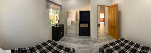 a living room with a couch and a window at TLT Guesthouses - Dauin in Dauin