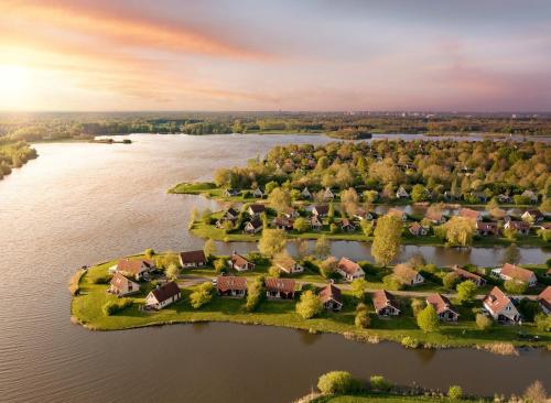 an aerial view of a home on an island in the water at Center Parcs Sandur Emmen in Emmen