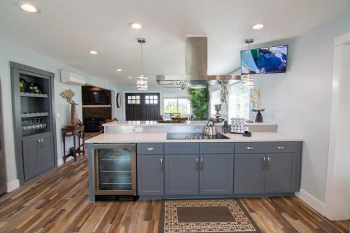 a kitchen with blue cabinets and a sink at Private Family Home With Gorgeous Yard in Camas