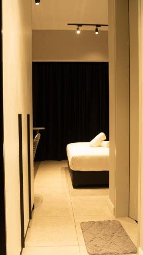 a small bedroom with a bed in a room at Axon Residence KLCC - KL HOME in Kuala Lumpur