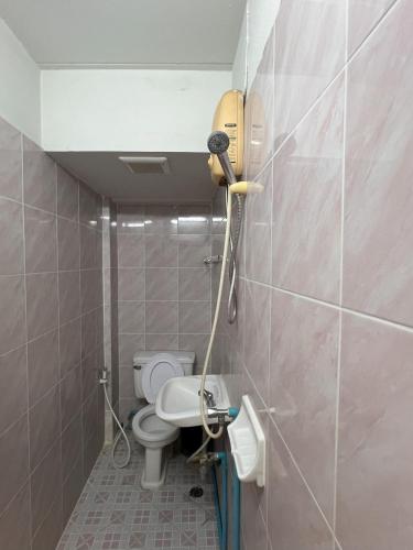 a bathroom with a toilet and a sink at Bella Bella House in Bangkok